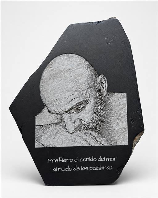 Retrato de hombre grabado en pizarra con una cita